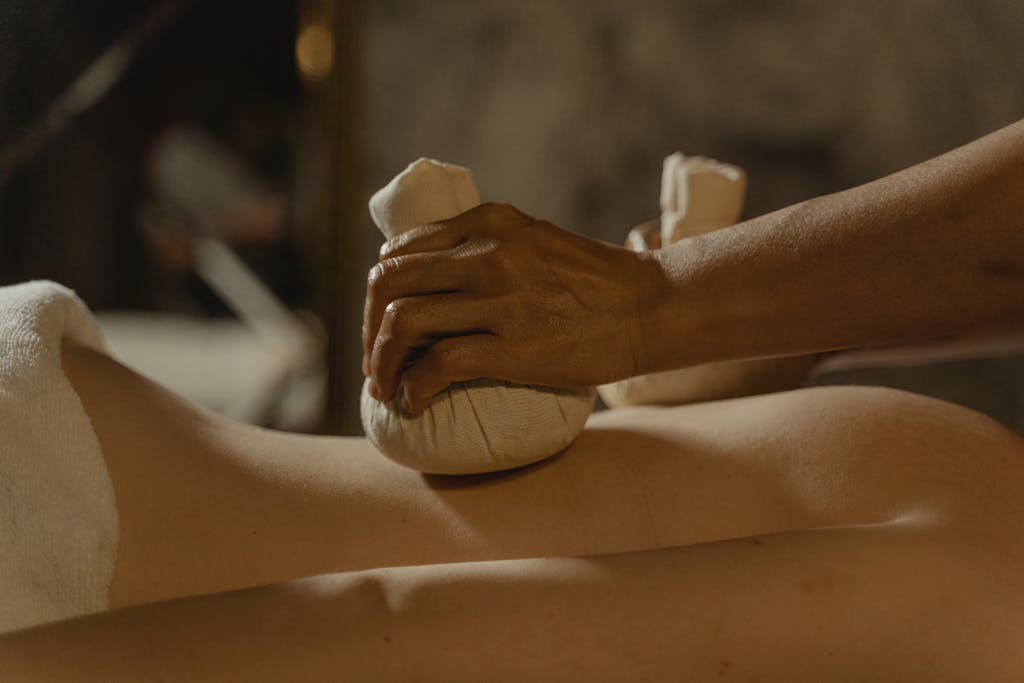 Home 29 Experience soothing relaxation with a herbal compress massage for ultimate wellness.